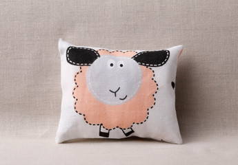 Sheep pillow on beige sofa