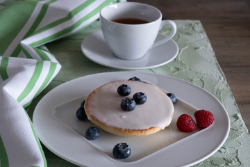 Cup of coffee and pastries on a plate.