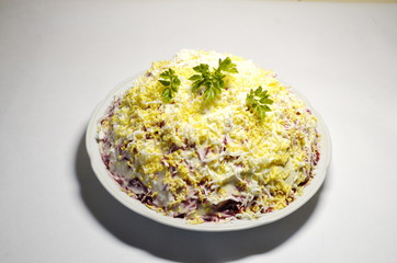 Home cooking, delicious food. On a white background, a plate with salad 