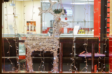 Christmas deer garland in a diner display case.