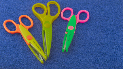 Scissors for scrapbooking on a blue background