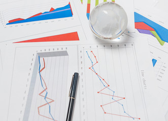 Business presentation with glboe and chart on the desk