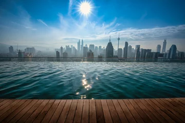Rolgordijnen Cityscape of Kuala lumpur city skyline with swimming pool on the roof top of hotel at daytime in Malaysia. © nuttawutnuy