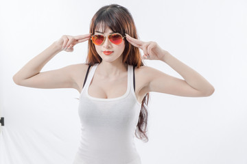 Beautiful woman wearing a white tank top with red glasses.