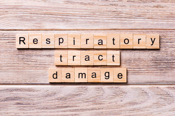 respiratory tract damage word written on wood block. respiratory tract damage text on wooden table for your desing, coronavirus concept top view