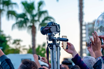 Professional camcorder in male hand outdoors