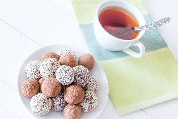 Homemade energy sweet balls-sweets with dried apricots, raisins, dates, prunes, walnuts, cashews and coconut. Indian vegetarian desserts. Healthy sweet food for tea drinking.