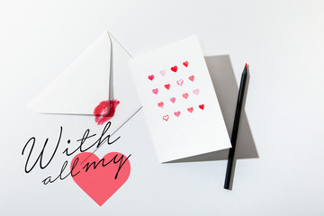 top view of greeting card with hearts near envelope with lip print near with all my lettering on white background