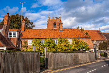 Pangbourne, Berkshire, England. October 29 2011 St. James the Less church tower showing above a row of cottages