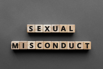 Sexual misconduct - words from wooden blocks with letters, sexual misconductconcept, top view gray...