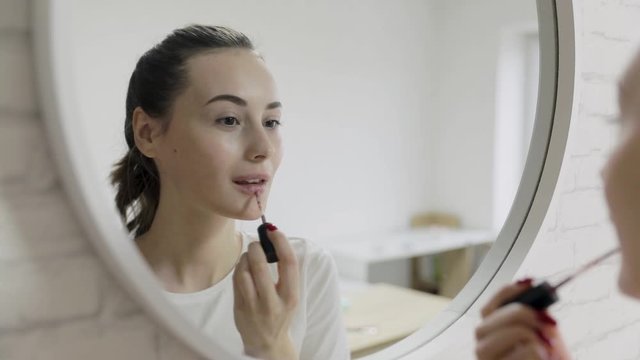 Woman using powder by brush make up in front mirror, Happy female using beauty cosmetics to improve herself ready to working in bedroom at home. Lifestyle women at home concept. Slow motion shot