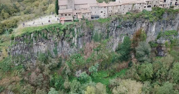Aerial view of Castellfollit de la Roca, medieval Catalan hamlet on cliff on autumn day