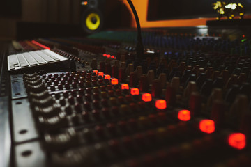 Fototapeta na wymiar Music producer working in music studio, controlling the sound mixer