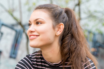 Portrait of a cheerful young woman outdoors