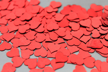 Close-up love many small red hearts as background.