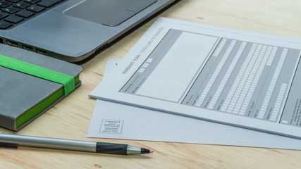 Desk view of a generic quality standard warranty forms with guarantee.