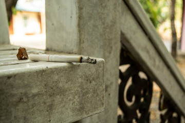 A cigarette lit on a chair and copy space