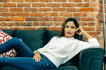 Young professional woman relaxed on sofa