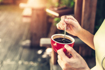 hand use spoon mix coffee in the morning.