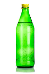Green glass bottle of mineral water on white background