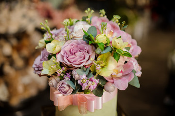 Round shape box full of tender color purple and green flowers