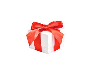Handmade white paper box with red satin ribbon and bow on an isolated white background.