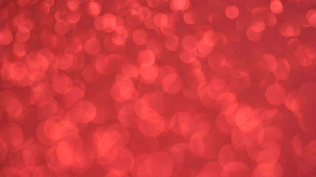 Blurred red background with holiday bokeh, abstract