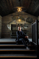 a man in black clothes is standing in a dark room in the loft style