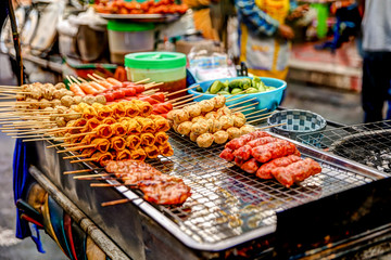 Street food for sale on a vendor cart in Bangkok
