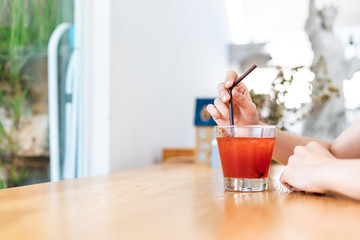 Women drink Juicy strawberry mixed juicy peach. Drink refreshment at sunny day.