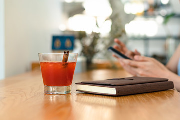 Juicy strawberry mixed juicy peach. Drink refreshment near book  at sunny day.