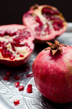 Pomegranates [Punica granatum] on silver tray