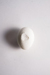 Broken eggs top view on a white background