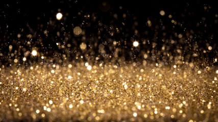 detail of glittering gold dust in movement.
