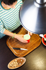 woman prepares yogurt on wooden cutting board