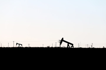 silhouette oil rig derricks field