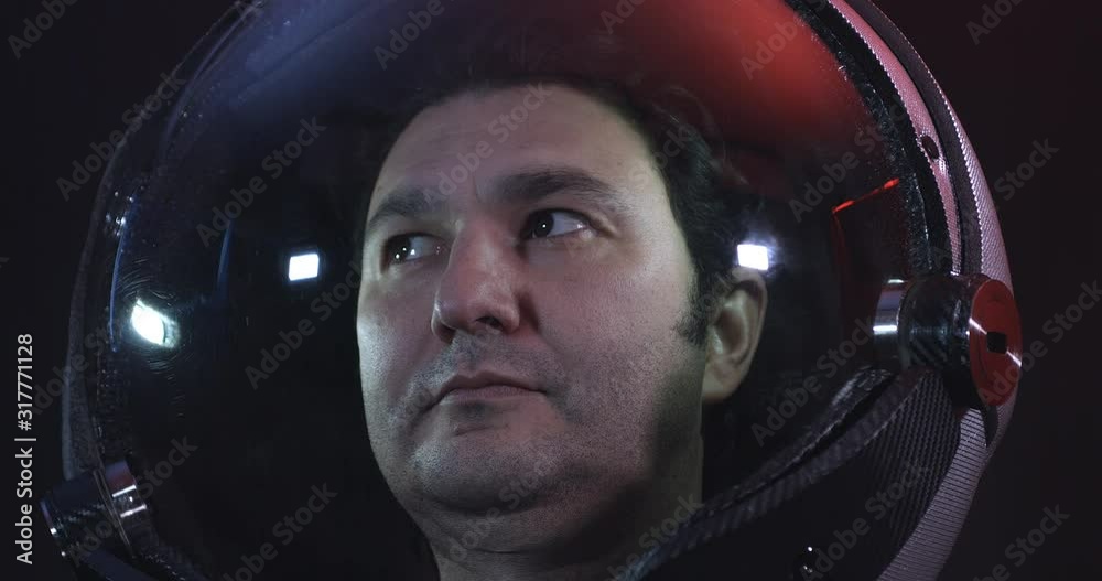 Wall mural portrait 4k shot of the young male astronaut in space helmet. he is exploring outer space in a space