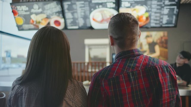 Couple cafe choosing dish and drinks to order.