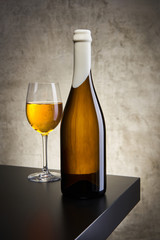 Red, white and rose wine bottles on vintage background