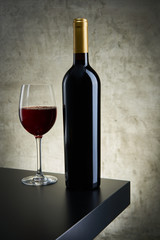 Red, white and rose wine bottles on vintage background