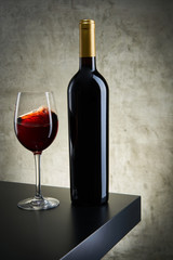 Red, white and rose wine bottles on vintage background