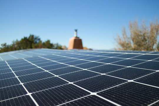 Close shot of a solar panel installation on a rooftop, in horizontal format