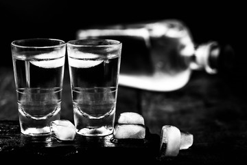 alcoholism, alcohol dependence. Chemical dependency. Alcoholism is the inability to control alcohol intake due to physical and emotional dependence. Bottles in black and white, dark photo.