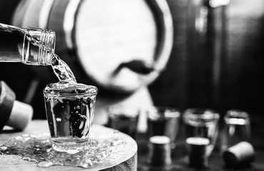 Black and white photos of bottles with alcohol. Concept of depression or addiction due to alcoholism.