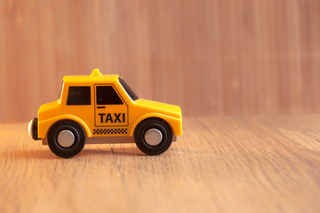 yellow taxi car, wooden background,