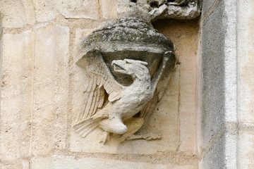 Fototapeta na wymiar Closeup architectural details of ancient historic castle or chateau in France - eagle sculpture