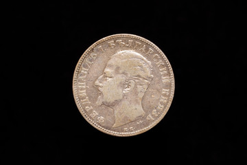 Old Bulgarian silver 2 leva coin from 1894, obverse showing Ferdinand I. Bulgarian Prince. Isolated on black background