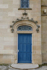 Fototapeta na wymiar Closeup architectural details of ancient historic castle or chateau in France - door and sculptures