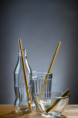 Eco-friendly glassware refillable with bamboo straws inside.