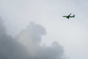 Passenger airplane flying above the clouds